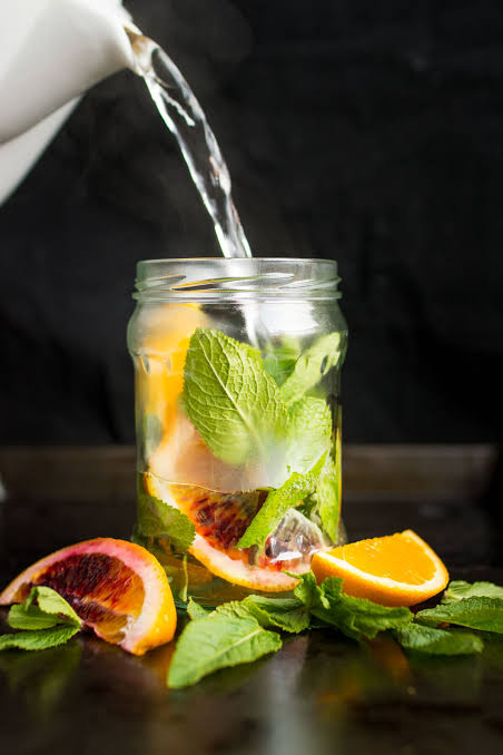 Fresh glass of water with citrus slices
